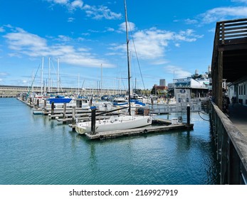 San Francisco, CA - May 28, 2022: SF Bay marina at Pier 39 with docked sail and house boats.