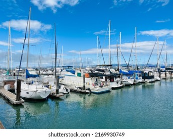 San Francisco, CA - May 28, 2022: Docked house and sail boats at Pier 39 Marina.