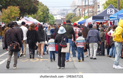 San Francisco, CA - May 29, 2021: Unidentified participants at Carnaval Festival in the Mission Distric, walking down the main street lined with venders selling their goods.