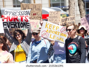 San Francisco, CA - May 7, 2022: Unidentified Participants holding signs marching in San Francisco at Women’s Rights Protest after SCOTUS leak plan to overturn Roe v Wade.