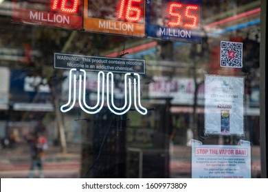 San Francisco, CA OCTOBER 5, 2019: Juul E-cigarette Vaping Neon Sign With Nicotine Warning Posted Outside Liquor Store