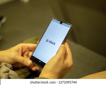 San Francisco, CA October 6, 2018: Woman Opening Slack Mobile Communication App With Logo On Android Screen While Commuting On Subway Train