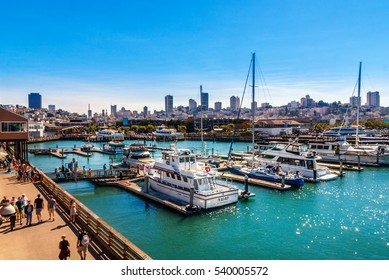SAN FRANCISCO, CA - SEPTEMBER 20, 2015: Yachts docked at Pier 39 Marina in San Francisco with city skyline in background. Pier 39 Marina features boat slips and provides guest docking and slip rental.