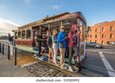 San Francisco, CA, United States - August 14, 2016: Cable Car Turntable or terminus, tourist attraction Powell-Hyde lines in Jefferson Street, Fishermen's Wharf. Passengers enjoy a ride in a cable car