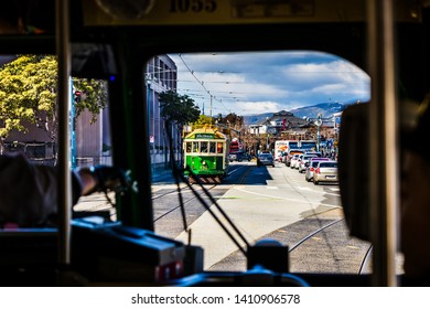 San Francisco, CA / USA - Circa March 2018: Streetcar Bus view looking out on Embarcadero street near Fisherman's Wharf, view of traffic, cable cars, parked  and moving cars  