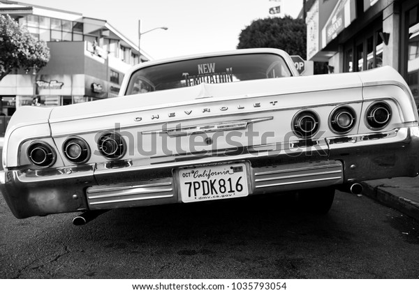 SAN\
FRANCISCO, CA, USA - FEBRUARY 25, 2018: A low rider classic car\
tilts to the left with its modified\
suspension.