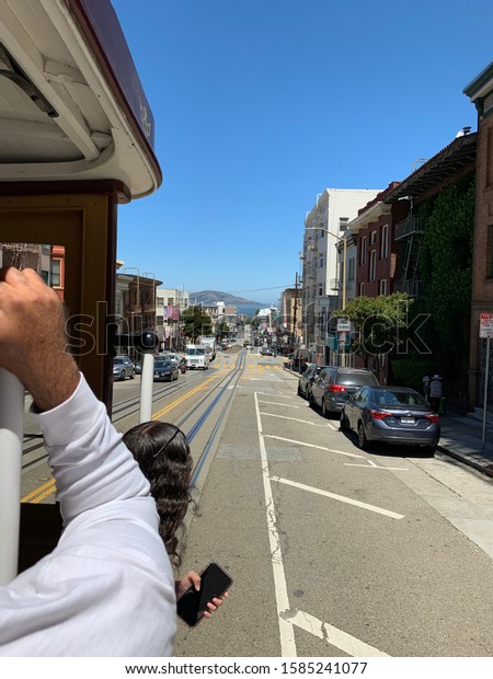 SAN FRANCISCO, CA, USA/ July 24, 2019:\
Street view of downtown San Francisco from a trolly showing busy\
life with cars, trucks and people passing\
by.
