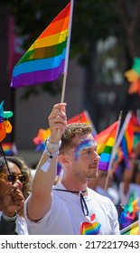 San Francisco, CA, USA - June 22, 2022: Pride Parade: Photo Shows A Member Of The Apple Pride Parade Group Carrying A Typical Pride Flag. 