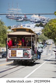 San Francisco, CA, USA - June 23rd, 2015: Tourists riding on a cable car in the Russian Hill district of San Francisco