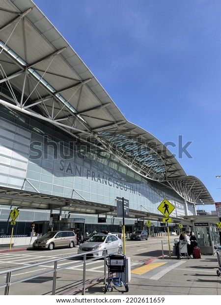 San Francisco, CA, USA - March 19, 2022 : side\
view of San Francisco International Airport with cars passing by on\
a sunny afternoon