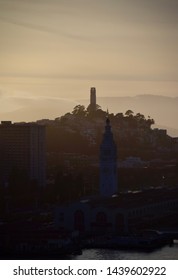 San Francisco, CA USA - May 23 2014: San Francisco's Coit Tower And Ferry Building In The Fading Daylight.