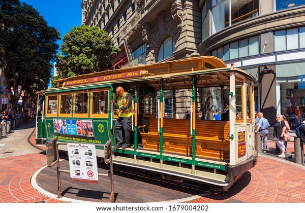 San Francisco, CA, USA -
September 8, 2019: An operator is about to push a cable car around
in the reverse direction at the Powell and Market Street
Turntable.