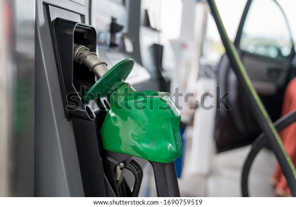 San Francisco,\
California June 2, 2019: Green diesel fuel nozzle in resting\
position at gas station\
pump