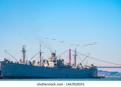 San Francisco, California - October 05 2017: San Francisco, California. Birds In A Row Over SS Jeremiah Obrien Warship And Golden Gate Bridge In The City. Summer Day In The Bay Area On West Coast