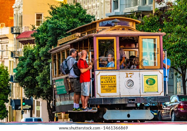 San Francisco, California - October 05 2017: San\
Francisco, California. Famous tourist attraction and unique public\
transportation commute, the open door Cable Car/ Tram/ Trolley on\
the city streets.