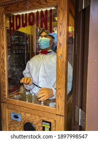San Francisco California on November 11, 2020. View of a Houdini booth that gives fortunes on Fishermans wharf. The Houdini is wearing mask due to COVID.