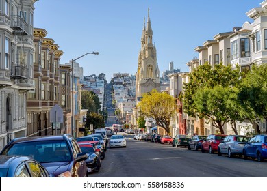 San Francisco, California, USA - January 1, 2017: A sunny winter afternoon street view of hillside neighborhoods on steep Filbert Street, with Saints Peter and Paul Church at middle.