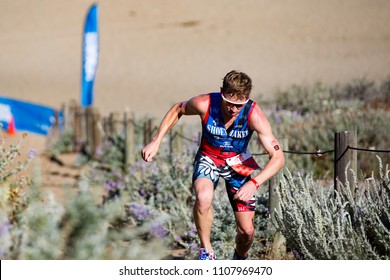 San Francisco, California, USA - June 3, 2018: Jarrod Shoemaker Searches For Footing On The Sand Ladder As He Races To Fifth Place At The 2018 Escape From Alcatraz Triathlon.