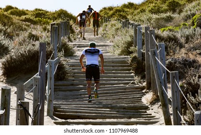 San Francisco, California, USA - June 3, 2018: Triathletes Climb The Sand Stairs At Baker Beach During The 2018 Escape From Alcatraz Triathlon.