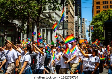 SAN FRANCISCO, CALIFORNIA / USA - JUNE 24, 2018: California LGBTQ Pride Parade. People wave rainbow flags on Market Street to support lesbians, gays, bisexuals, transgenders and queers.
