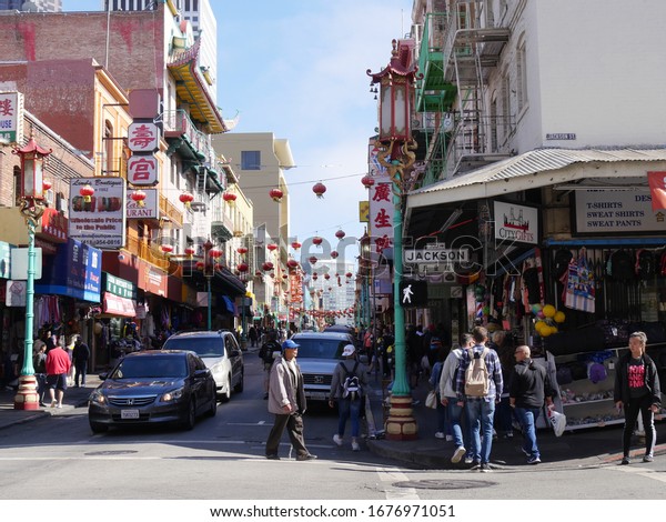 San Francisco,\
California-July 2018: Busy street in Chinatown, with shoppers\
walking on the streets.
