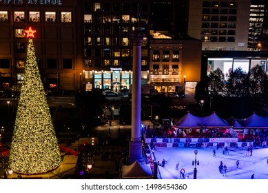 San Francisco, California/USA-12/13/18: Christmas Time At Night Union Square Park Looking From Above Showing A View Of The Lit Christmas Tree And Ice Skating Rink, Surrounded By Department Stores