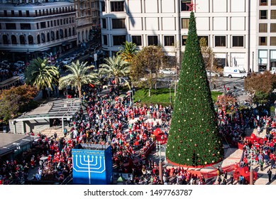 San Francisco, California/USA-12/8/18: Union Square Park Christmas Time During Santa Con And Toys For Tots Seen From A Birds Eye View Above Showing Flash Mob Christmas Tree And Surrounding Stores