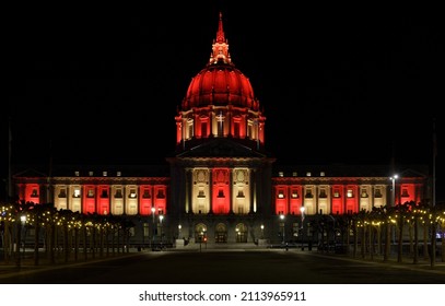 San Francisco City Hall Lit In Red And Gold At Night