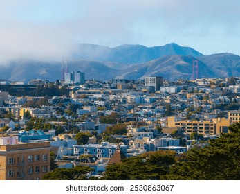 San Francisco cityscape with diverse architecture, rolling hills, and the Golden Gate Bridge partially obscured by fog in the background. - Powered by Shutterstock