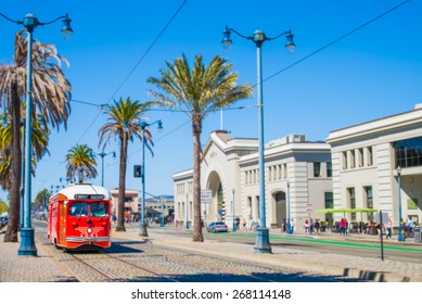 San Francisco f- streetcar, tram or muni trolley traveling down the Embarcadero on a sunny day.  Vintage streetcar originally a Pacific Electric car built in 1948 trolley.  Tribute livery.
