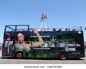 San Francisco  - July 9, 2009: Tour Bus With Weeds Showtime TV Show Ad On Side And  Ferry Terminal In The Background In California.



