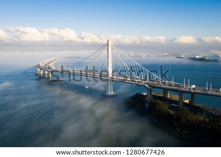 San Francisco - Oakland Bay Bridge Above Layer or Low Fog