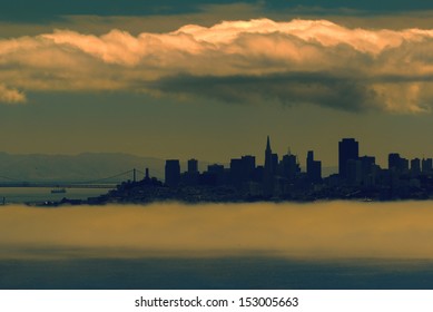 San Francisco Skyline Under Dramatic Clouds And Fog