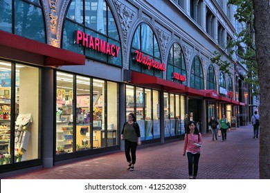 SAN FRANCISCO, USA - APRIL 8, 2014: People walk by Walgreens pharmacy and food mart in San Francisco, USA. Walgreen Co is the largest drugstore chain in the USA by sales.