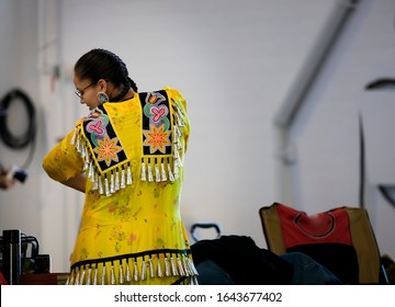 San Francisco, USA - February 08, 2020: Native American Indian Girl Dressed In Intricate Traditional Jingle Dress Preparing To Dance At A Powwow