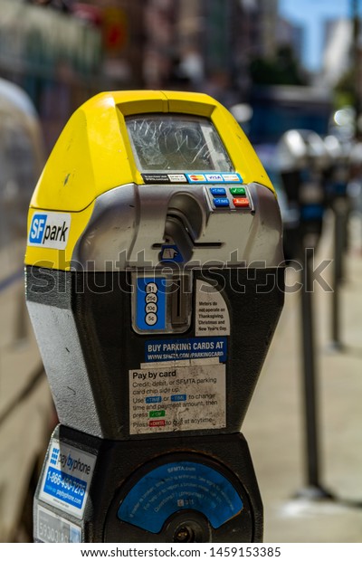San Francisco, USA - July 10, 2019, the SFPark\
parking meter on the street in San Francisco, parking in the city\
is a constant problem for residents, a close-up view with a blurred\
depth of field