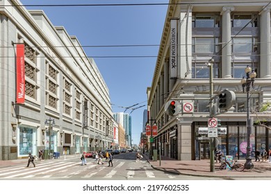 San Francisco, USA - June 6, 2022: People At Market Street Downtown In San Francisco, California With Rainbow Flag For Gay People Fluttering At An Old Historic Lantern.