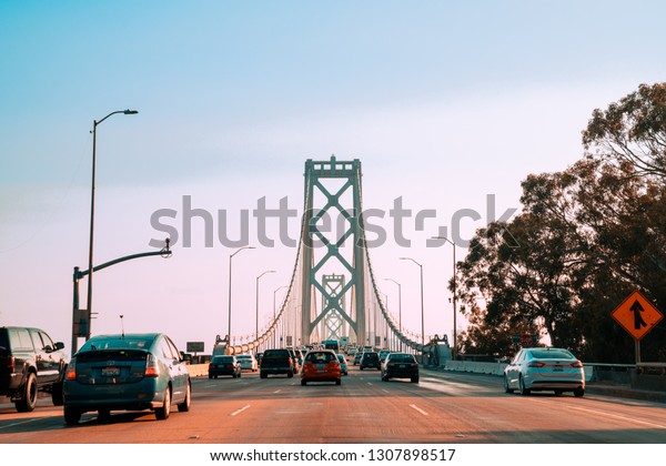 San Francisco, USA. May 10, 2018. Busy streets\
of San Francisco with heavy traffic, cable cars and golden gate\
bridge highway.