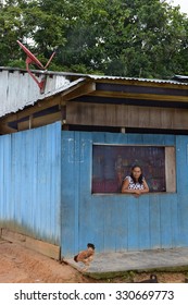 SAN FRANCISCO VILLAGE, PERU - OCTOBER 16, 2015: Woman In Window Of Bodega. Small Stores Are Staple In The Peruvian, Amazon Region.