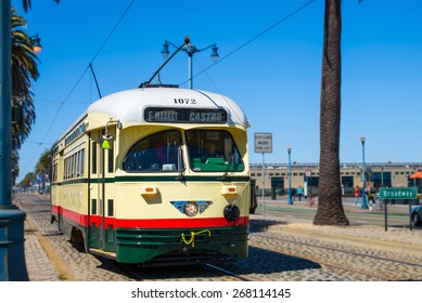 San Francisco vintage f- streetcar, train, tram or muni cable trolley car traveling down the Embarcadero on a sunny day.  Originally a Mexico City car built in 1946 trolley.  Tribute livery.