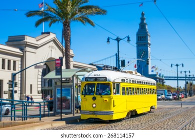 San Francisco vintage f- streetcar, train, tram or muni cable trolley car traveling down the Embarcadero on a sunny day.  Originally a Baltimore Maryland car built in 1948 trolley.  Tribute livery.