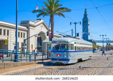 San Francisco vintage f- streetcar, train, tram or muni cable trolley car traveling down the Embarcadero on a sunny day.  Originally a New Jersey car built in 1947 trolley No 1070   Tribute livery.