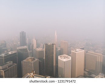 San Francisco,California,United States - November,16,2018 - Aerial Haze View Of Financial Downtown District With Skyscrapers Building In Smoke Produced By Wildfire. Unhealthy Toxic Fire Air Pollution