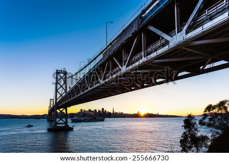San Francisco-Oakland Bay Bridge and cityscape at sunset