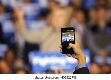 SAN GABRIEL, LA, CA - JANUARY 7, 2016, Through A Smart Phone, We See On The Screen Democratic Presidential Candidate Hillary Clinton Speaking To Asian American And Pacific Islander (AAPI) Members