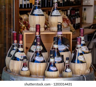 San Gimignano, Italy - 09/28/2018: Bottles of Chianti on Display Along the Streets of San Gimignano
