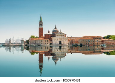 San Giorgio Maggiore island in Venice, Italy. Beautiful view of San Giorgio Maggiore church, sky and mirror reflection in water. Skyline, panorama of old buildings in sea. Landscape and travel theme.