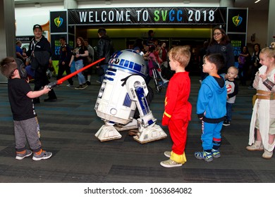 San Jose, CA - April 07, 2018: Unidentified Participants At The Silicon Valley Comic Con. Celebrating Technology, Science And Entertainment All Under One Roof. Young Kids Curious About R2D2 Drone.