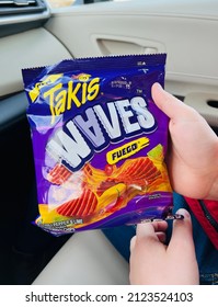 San Jose, CA - January 30, 2022: Closeup Of Boy Holding A Bag Of Takis Waves Hot Chips Inside A Car.