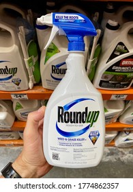 San Jose, CA - July 12, 2020: Man Holding A Spray Bottle Of Popular RoundUp Weed And Grass Killer By Monsanto Corporation Inside A Home Improvement Store. 